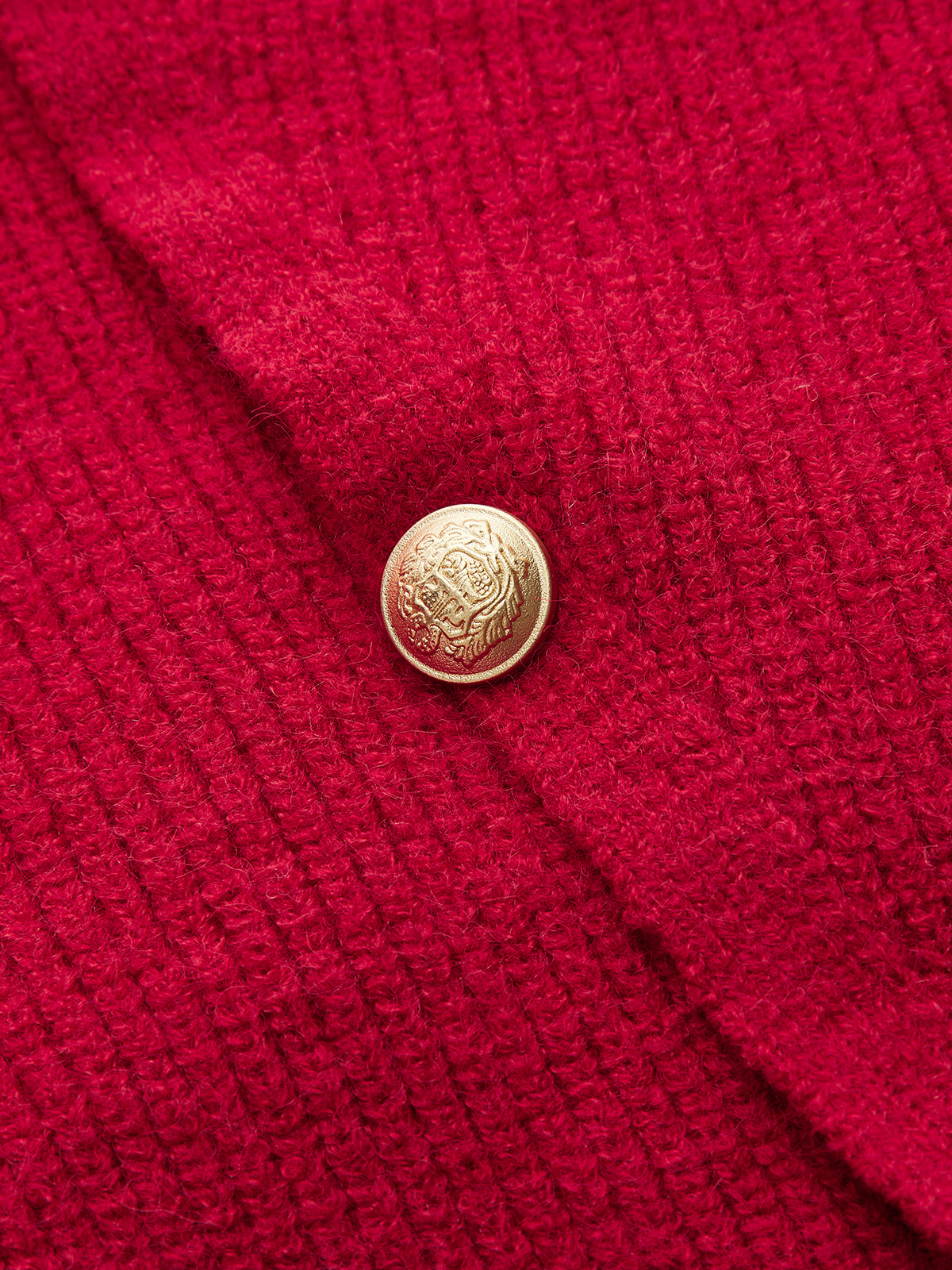 Sweter z asymetrycznym zapięciem na guziki