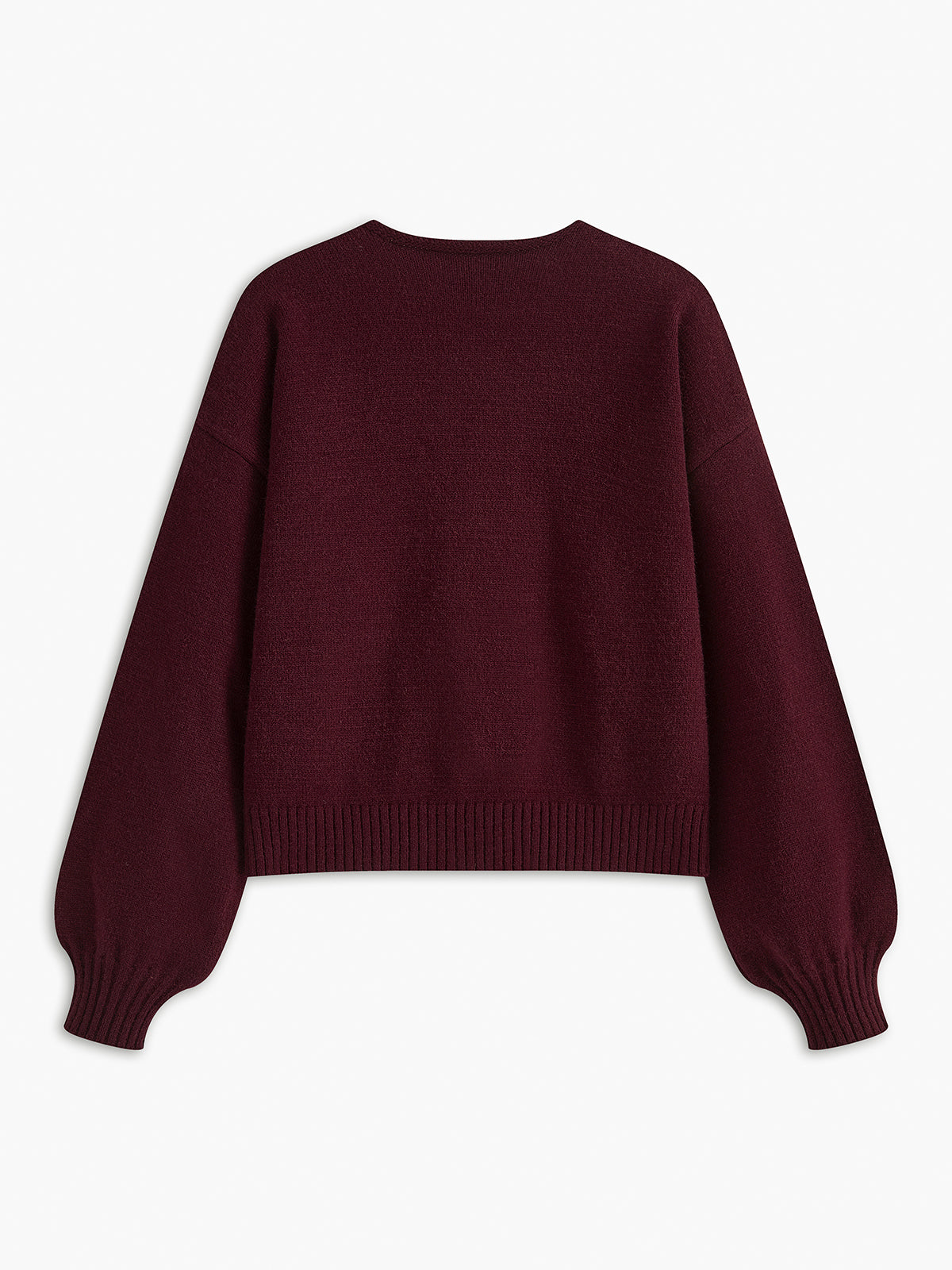 Sweter z ozdobnymi kokardkami na guziki